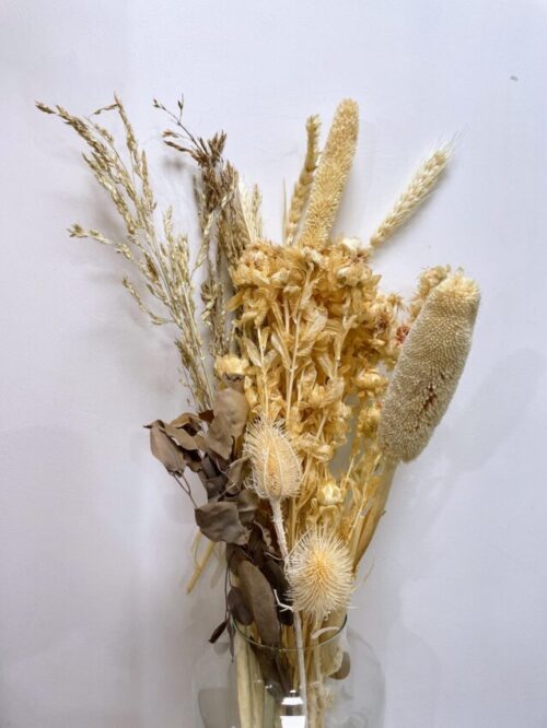close up of Dried Natural Flowers in a Rustic Bouquet on white background
