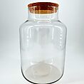 Elegant glass jar with cork lid, perfect for storage or decorative purposes in any home.