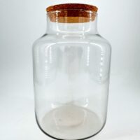 Elegant glass jar with cork lid, perfect for storage or decorative purposes in any home.