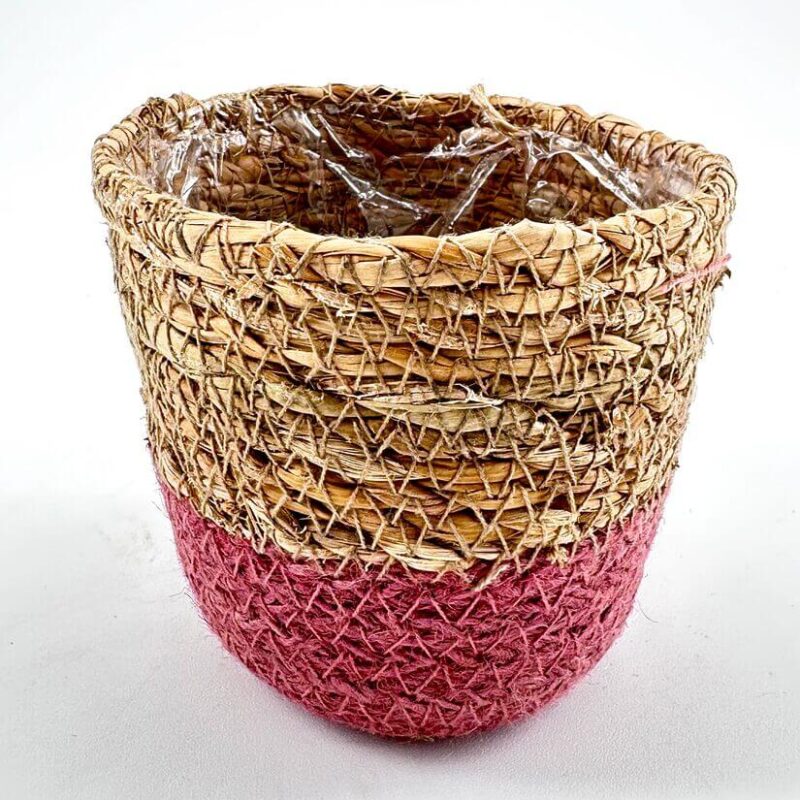Basket Planter Handmade rustic basket with straw fibres, red dye, and plastic lining for decor or plants.