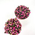 Vibrant pink and green heart-shaped succulent leaves in terracotta pots.