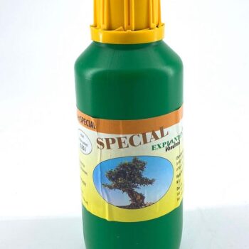 Green plastic bottle with yellow cap, labelled SPECIAL EXP, featuring healthy tree image.