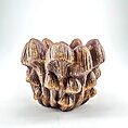 Ceramic mushroom sculpture with earthy textures and colors, showcasing intricate natural details.