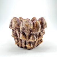 Ceramic mushroom sculpture with earthy textures and colors, showcasing intricate natural details.