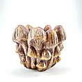 Sculpture of earthy-toned mushroom cluster highlighting natural textures and intricate organic design.