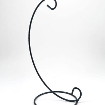 Minimalist black metal wire stand with elegant curved design for displaying decorative items.