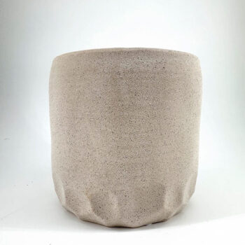 Elegant handcrafted ceramic pot with minimalist design, speckled texture, sandy beige colour.