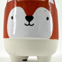 Charming ceramic fox planter with orange accents, ideal for succulents or decorative storage.
