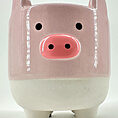 Playful ceramic pig figure with vibrant pink and white colors, glossy finish, and charming design.
