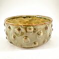 Artisan ceramic bowl with unique textures and earthy tones, ideal for decor or serving.
