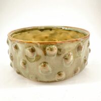 Artisan ceramic bowl with unique textures and earthy tones, ideal for decor or serving.