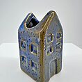 Whimsical ceramic house decoration with vibrant blue glaze and textured brickwork design.