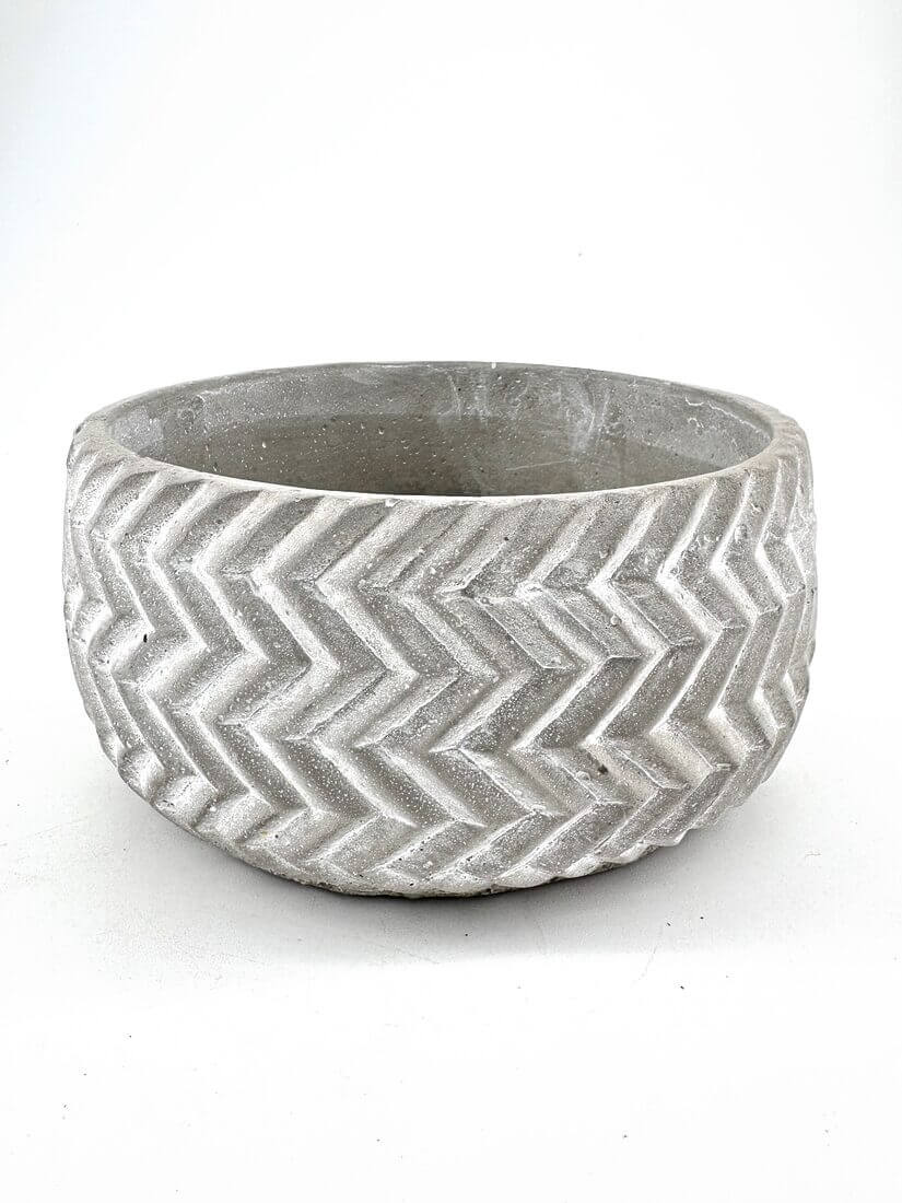 Stylish concrete chevron planter, perfect for indoor or outdoor greenery display.
