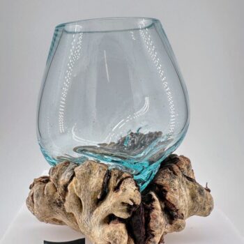 Decorative glass vase on rustic wood base, blending modern design with natural elegance.
