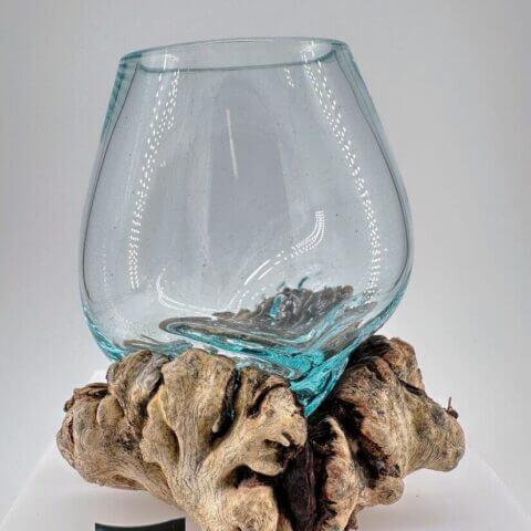 Decorative glass vase on rustic wood base, blending modern design with natural elegance.