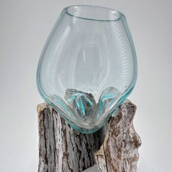 Elegant glass and wood art piece, featuring a textured aqua vessel on a sculptural base.