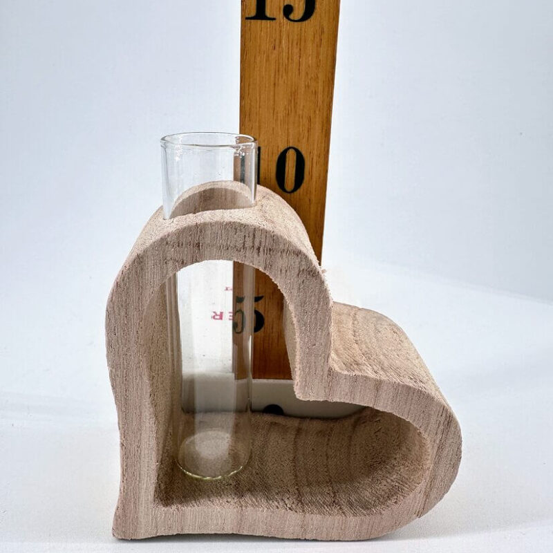 Charming Heart-Shaped Wooden Holder with Test Tube Heart-shaped wooden holder with test tube and ruler, perfect for decorative home or workspace display.