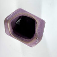 Unique lavender hexagonal ceramic vase with contrasting black interior, perfect for home decor.
