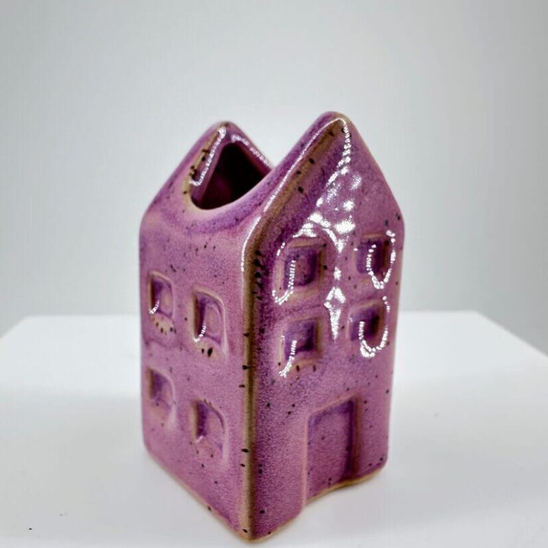 Whimsical Lavender Ceramic House Planter Whimsical lavender ceramic house sculpture perfect for home decor or as a charming planter.