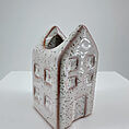 Whimsical lavender ceramic house vase, perfect for charming home decor and floral displays.
