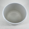 Glossy white bowl on neutral background, showcasing minimalist design and elegance.