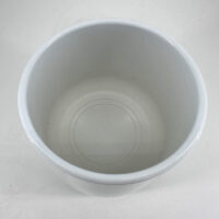 Glossy white bowl on neutral background, showcasing minimalist design and elegance.