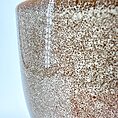 Intricate ceramic bowl close-up showcasing earthy speckled texture and artisanal craftsmanship.