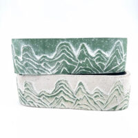 Stylish mountain-themed ceramic pots in green and beige, perfect for home decor and plant displays.