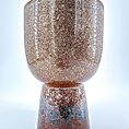 Contemporary ceramic vessel with textured earthy tones, perfect for decoration and functional use.