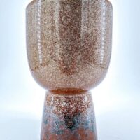 Contemporary ceramic vessel with textured earthy tones, perfect for decoration and functional use.