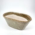 Elegant textured ceramic vessel with clear water, perfect for decorative or functional use.