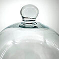 Elegant glass cloche showcasing stunning craftsmanship and reflections, perfect for home decor.