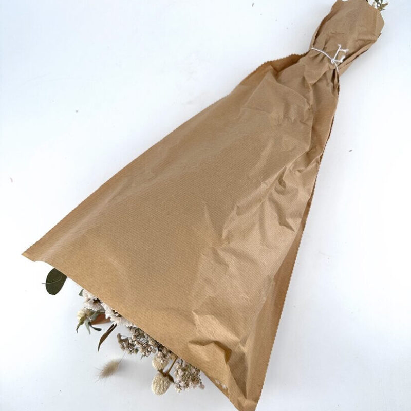Charming Dried Flower Bouquet in Kraft Paper Beautifully wrapped dried flower bouquet in rustic kraft paper, tied with twine.
