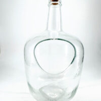 Elegant glass bottle with modern design and cork stopper, featuring a unique cutout for functionality.