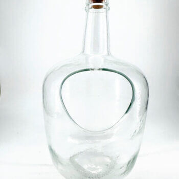 Elegant glass bottle with modern design and cork stopper, featuring a unique cutout for functionality.