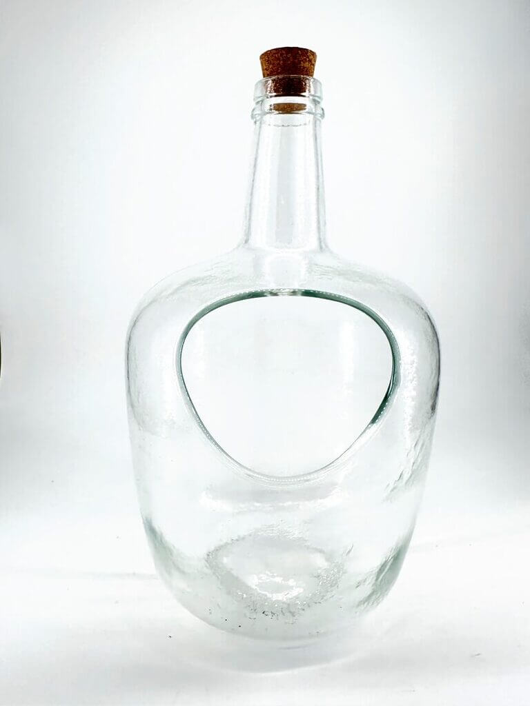 Elegant glass bottle with modern design and cork stopper, featuring a unique cutout for functionality.