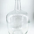 Clear glass bottle with cork stopper, perfect for storage or decorative use.