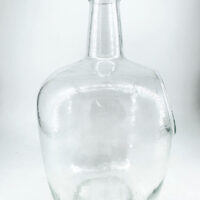 Clear glass bottle with cork stopper, perfect for storage or decorative use.