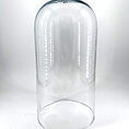 Elegant glass cloche for displaying food and decorative items with a modern design.