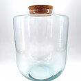 Clear glass jar with cork lid, ideal for storage or decorative display.