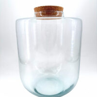 Clear glass jar with cork lid, ideal for storage or decorative display.