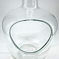 Elegant glass decanter with modern design, featuring a unique cutout and smooth, polished finish.