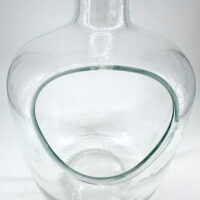 Elegant glass decanter with modern design, featuring a unique cutout and smooth, polished finish.