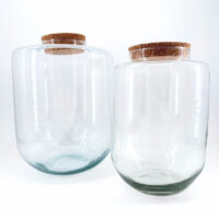 Elegant glass jars with cork lids, perfect for storage or decorative home styling.
