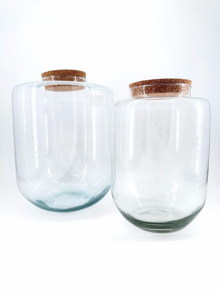 Elegant glass jars with cork lids, perfect for storage or decorative home styling.