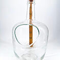 Artistic glass measuring bottle with cork, ergonomic design, and bold scale for precision.