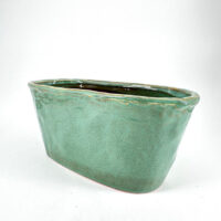 Elegant turquoise ceramic planter with glossy finish, perfect for modern home and garden decor.