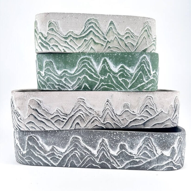 Stylish Mountain-Themed Planters for Natural Home Decor Stacked mountain planters with unique designs in various colours, adding a natural touch to decor.