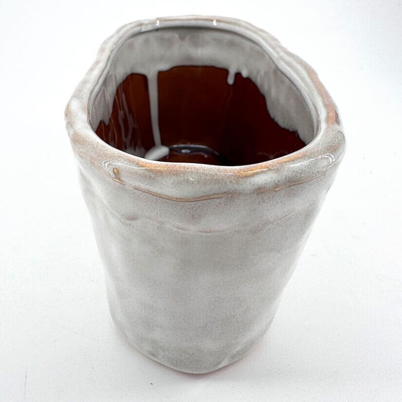 Elegant Handcrafted Ceramic Vessel with Organic Charm Unique handcrafted ceramic vase with organic shape, glossy finish, and earthy colour variations.