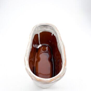 Elegant ceramic vessel in cream and brown glaze, perfect for décor or culinary presentation.